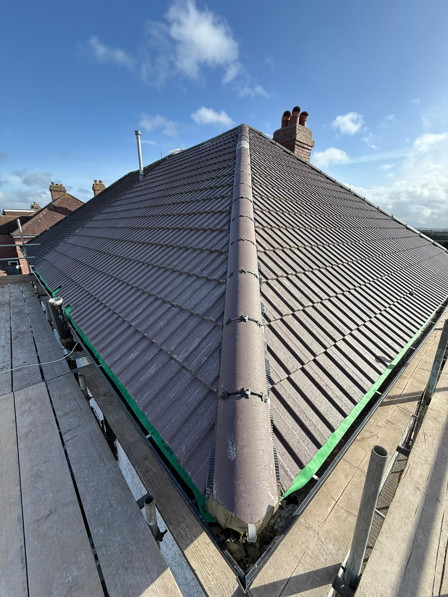 Grey tiled roof viewed from the ridge