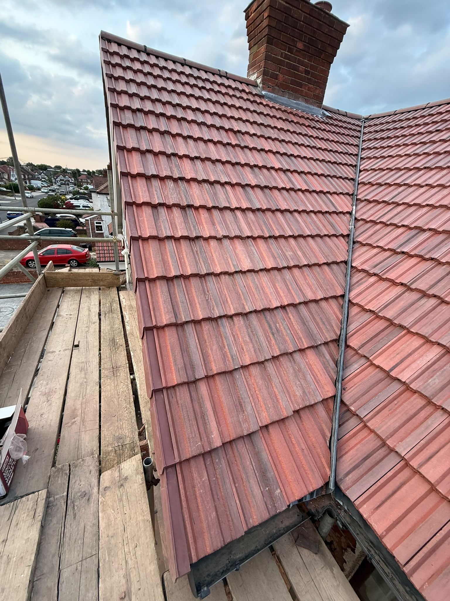 Red tiled roof beside a brick chimney