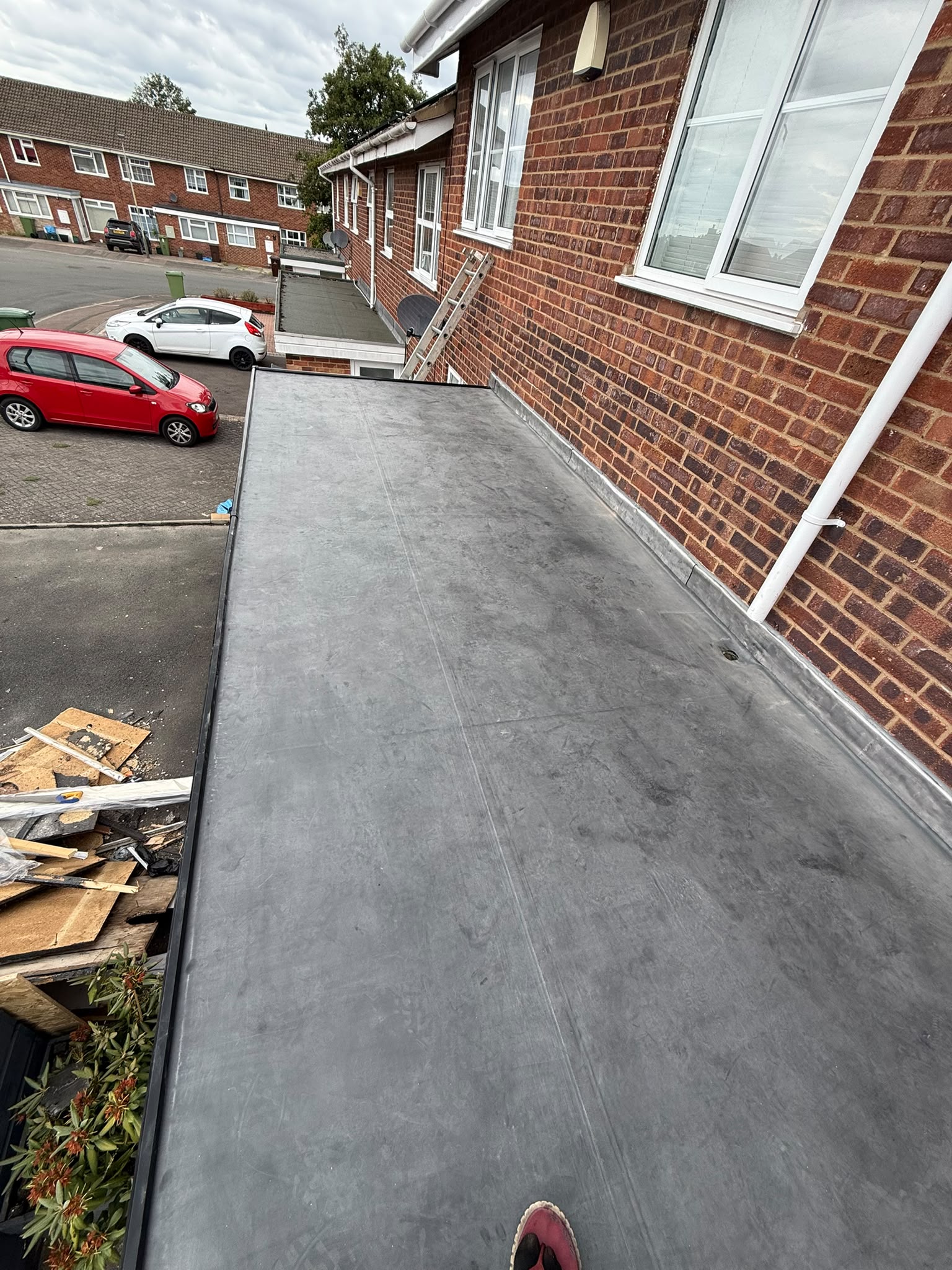 Flat extension roof alongside brickwork