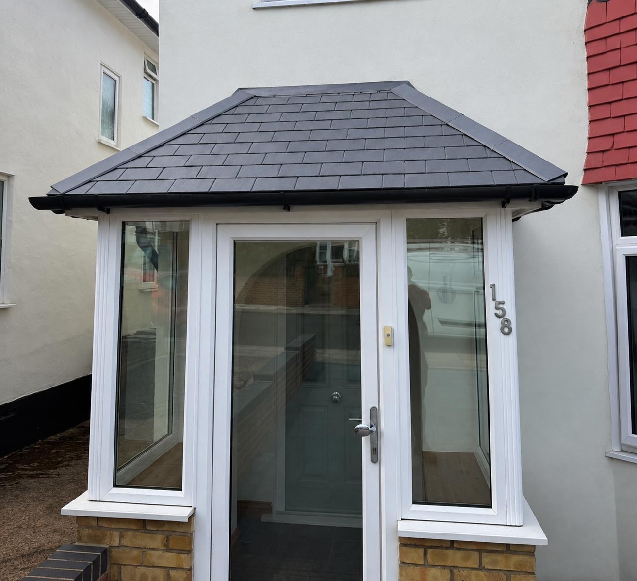 Small grey tiled roof above a front entrance