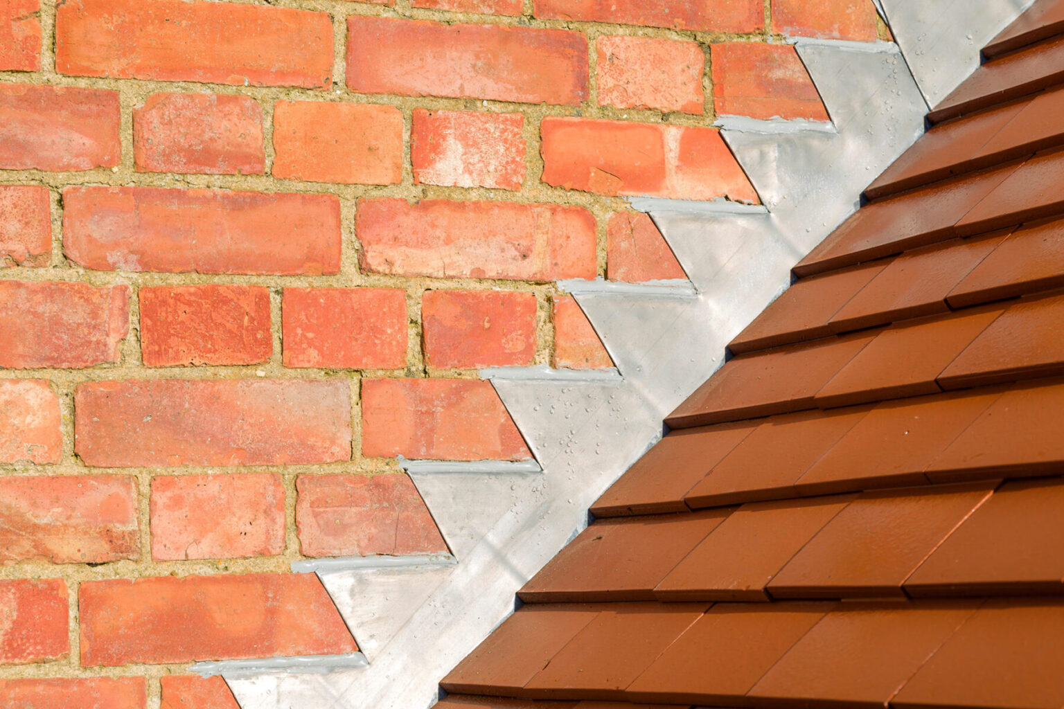 Leadwork and tiled roof junction