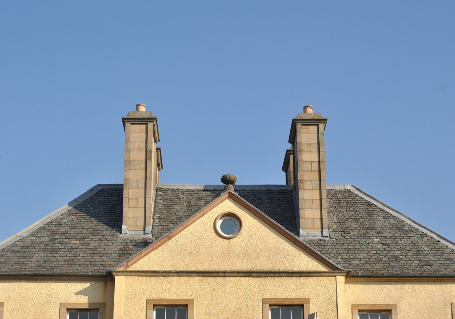 Traditional slate roofing and chimney stacks